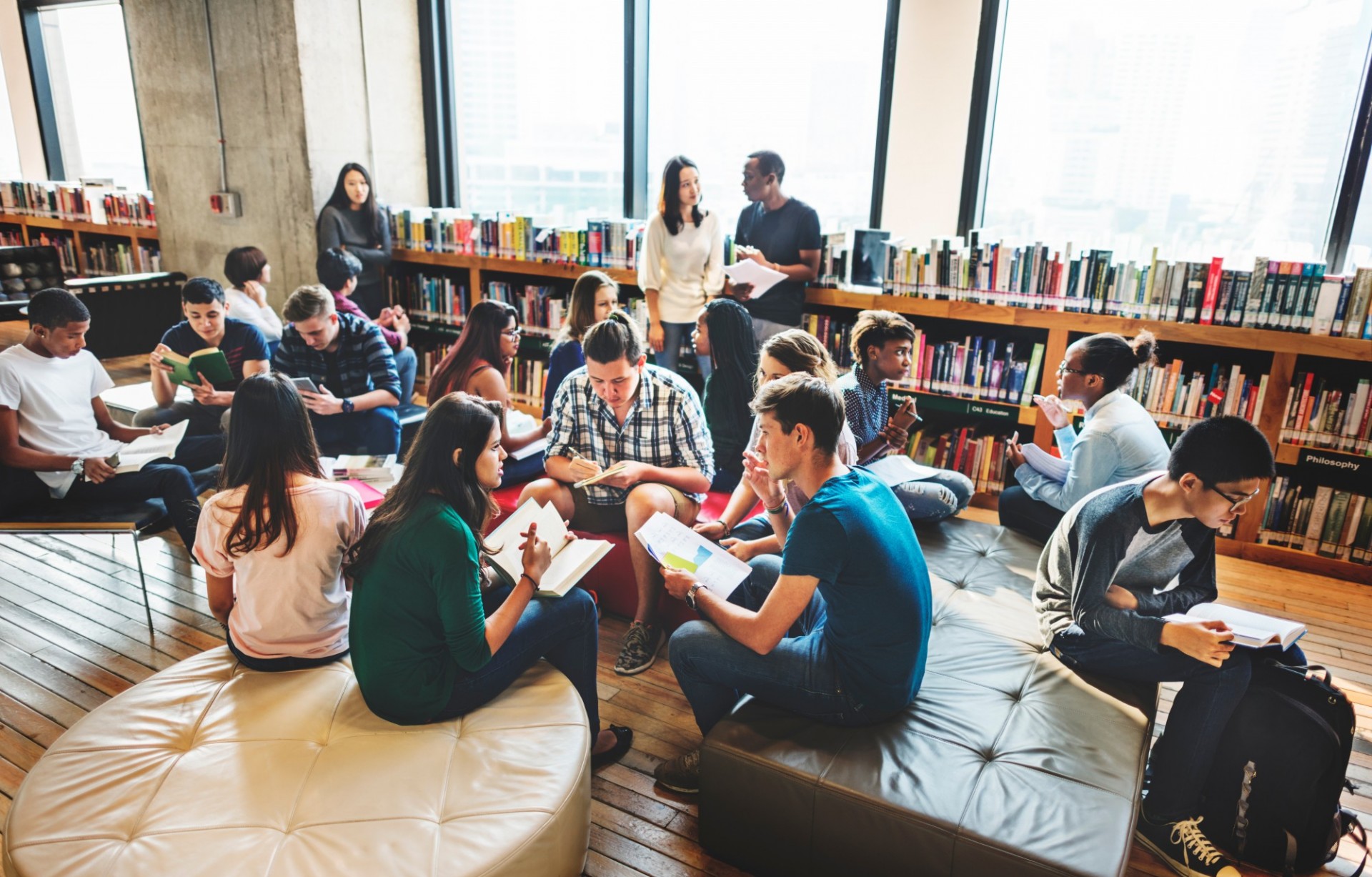 Students working together in groups in the library