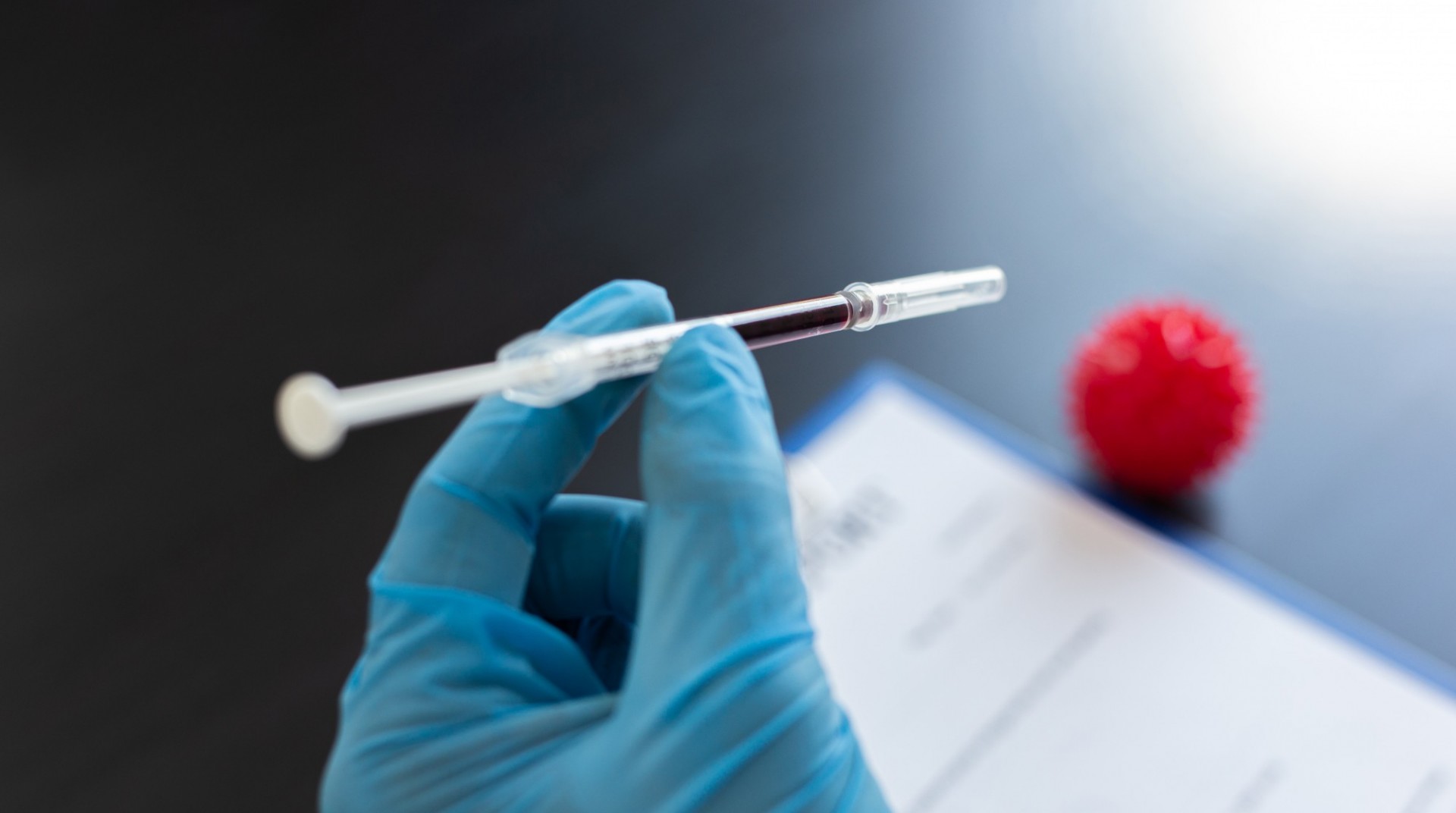 Sentinel Systems that Detect, Recognize, Actuate, and Mitigate Emergent Biological Threats Closeup of a scientist's gloved hand looking at a vaccination needle